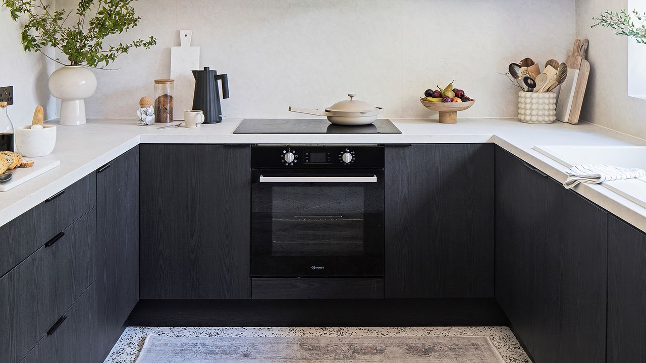 Black u-shaped kitchen with open shelving