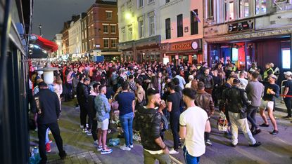 A crowd gathers in Soho, London despite social distancing measures.