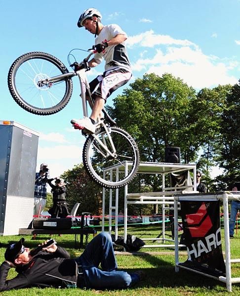 Announcer Richard Fries risking his life as a rider jumps his prostrate body.