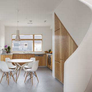 white kitchen with worktop and dining table