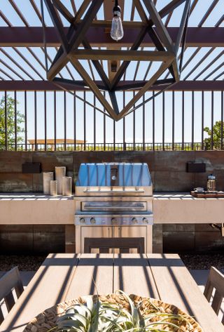 outdoor grill covered by a pergola