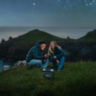 Couple using Dwarf III telescope at night