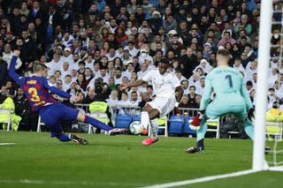 Vinicius opened the scoring via a deflection off Pique (left)