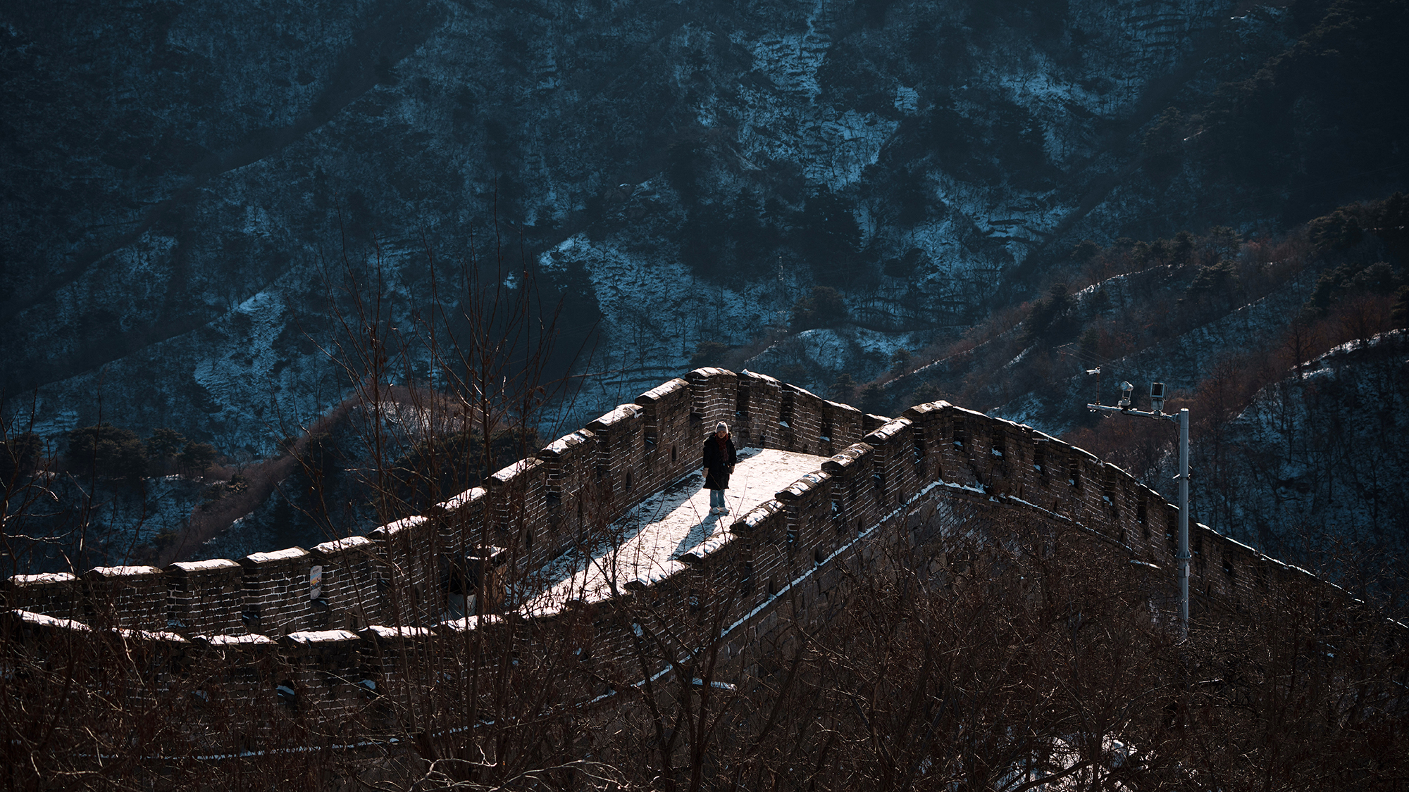 A tourist walks along the Juyongguan section of the Great Wall on the outskirts of Beijing, China