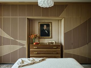 Photo of custom-built dresser with concealed TV in bedroom