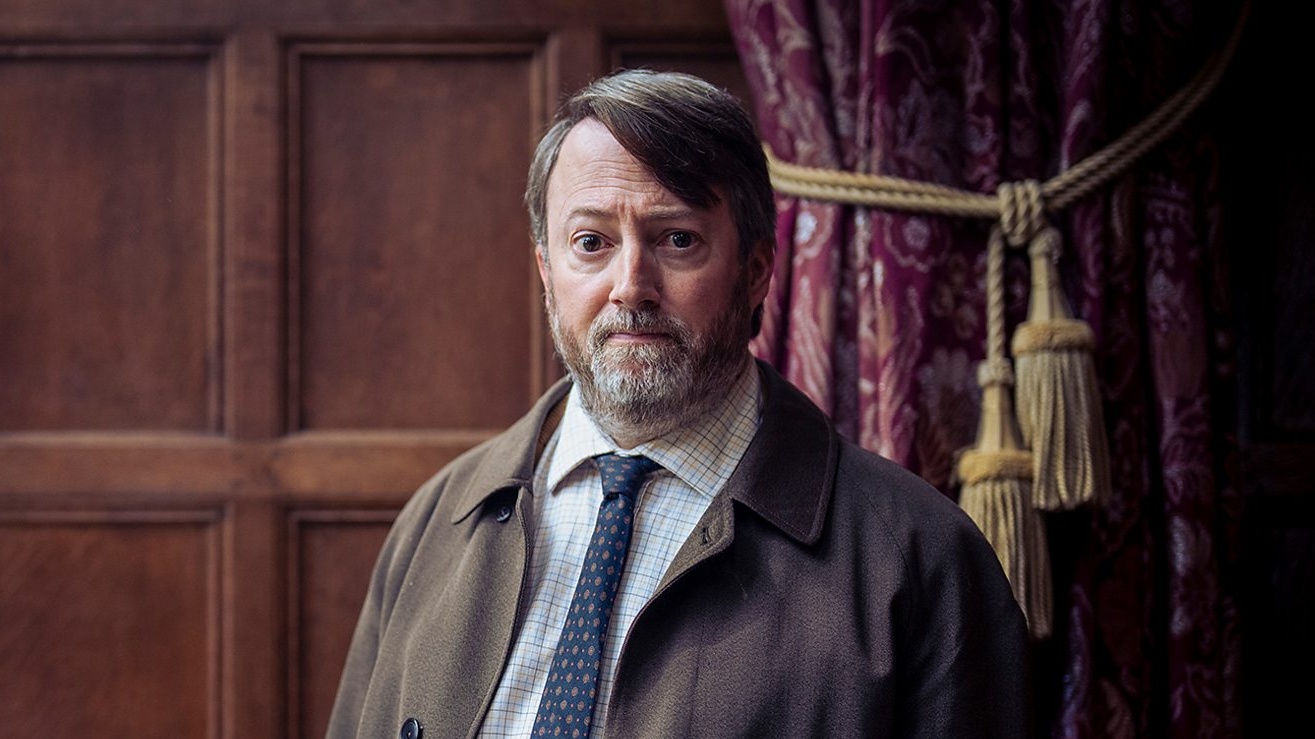 David Mitchell in blue tie and brown jacket in BBC detective show Ludwig season 2 (2026) 