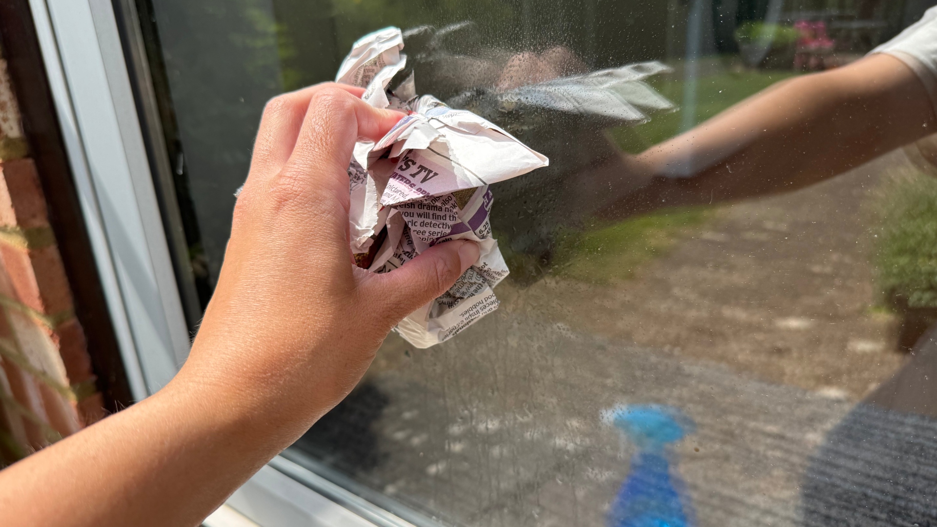 Using newspaper and vinegar to clean a window