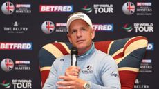 Luke Donald speaks into a microphone while sitting on a Union Jack-pattern chair at the 2025 British Masters