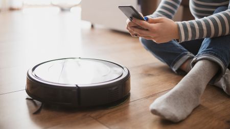 a smart vacuum being set up with a smart phone