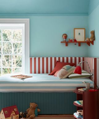 kids bedroom with blue walls, red striped bed