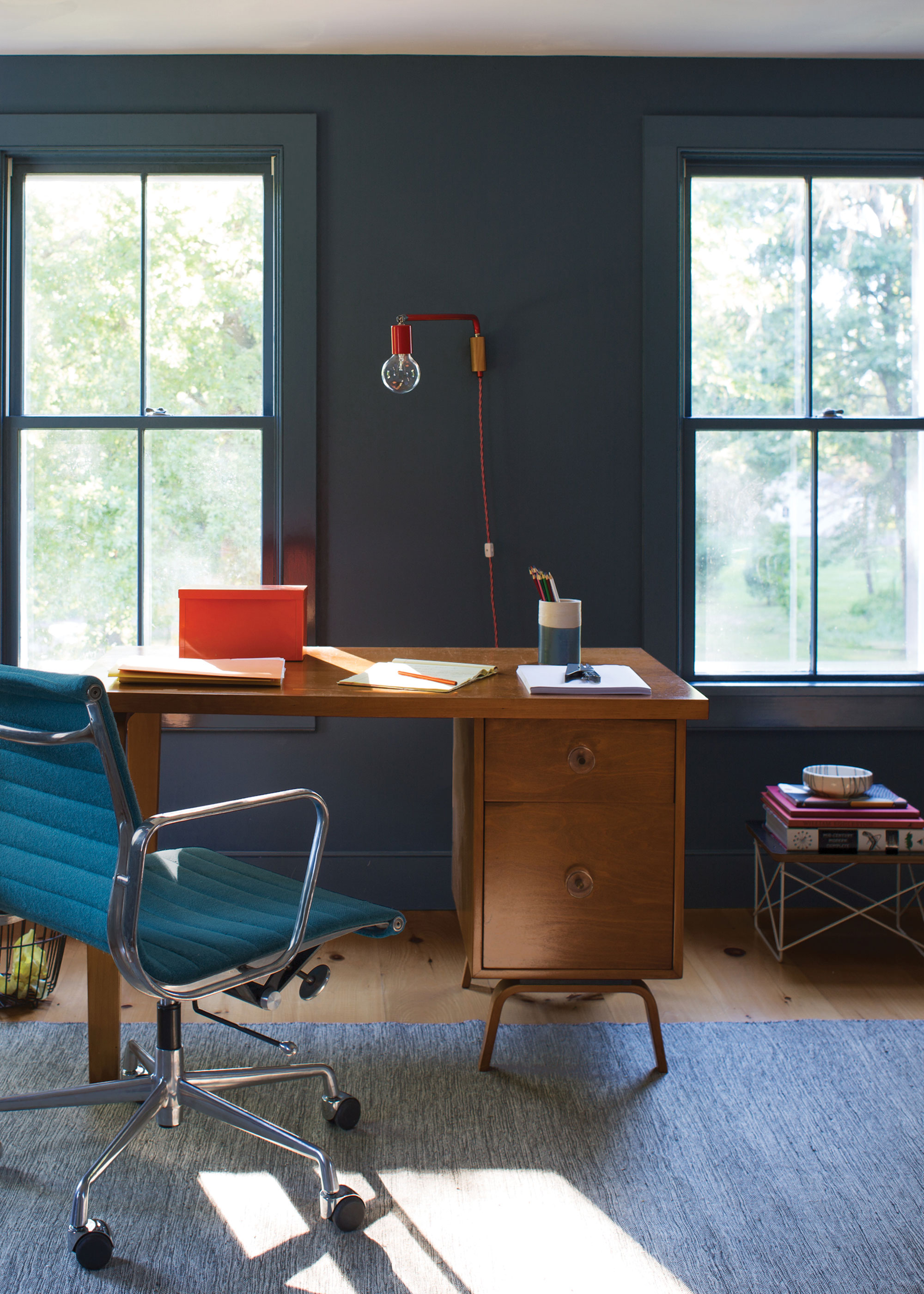 dark blue home office with wooden desk