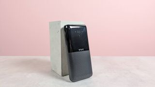 VRURC 20000mAh 20W Power Bank leaning on plinth on table with pink background