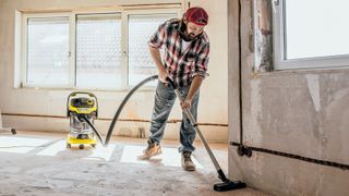 Man vacuuming house renovation with Karcher wet and dry vac