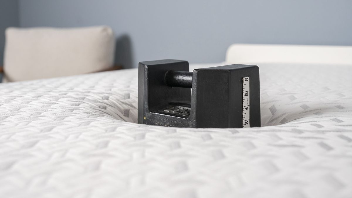 Image shows a 56lb black weight placed on one side of the Nectar Premier Memory Foam Mattress where one of our testers would lie to test the sinkage. From there we can work out pressure relief and how well this mattress distributes body weight and relieves pressure points