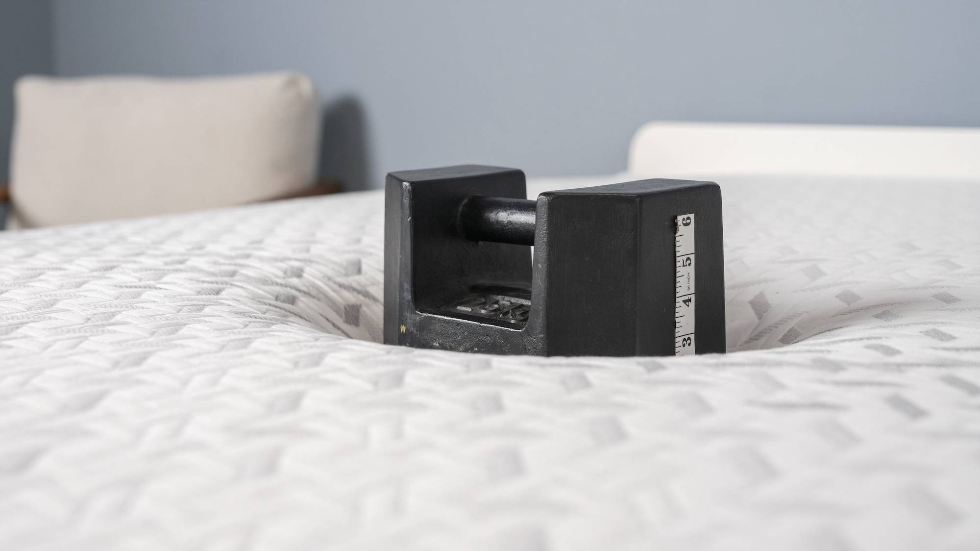 Image shows a 56lb black weight placed on one side of the Nectar Premier Memory Foam Mattress where one of our testers would lie to test the sinkage. From there we can work out pressure relief and how well this mattress distributes body weight and relieves pressure points