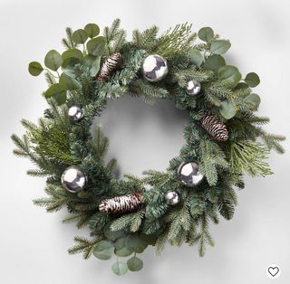 Christmas wreath cut out with silver baubles and pine cones