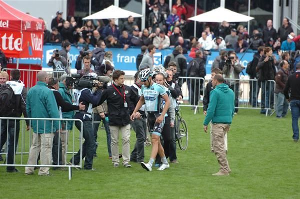Boonen walks to greet the press after his victory