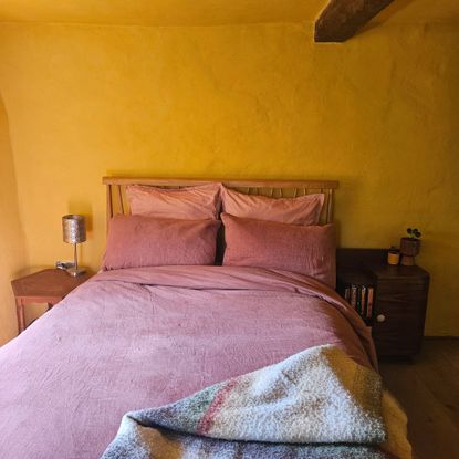yellow bedroom with red bedding