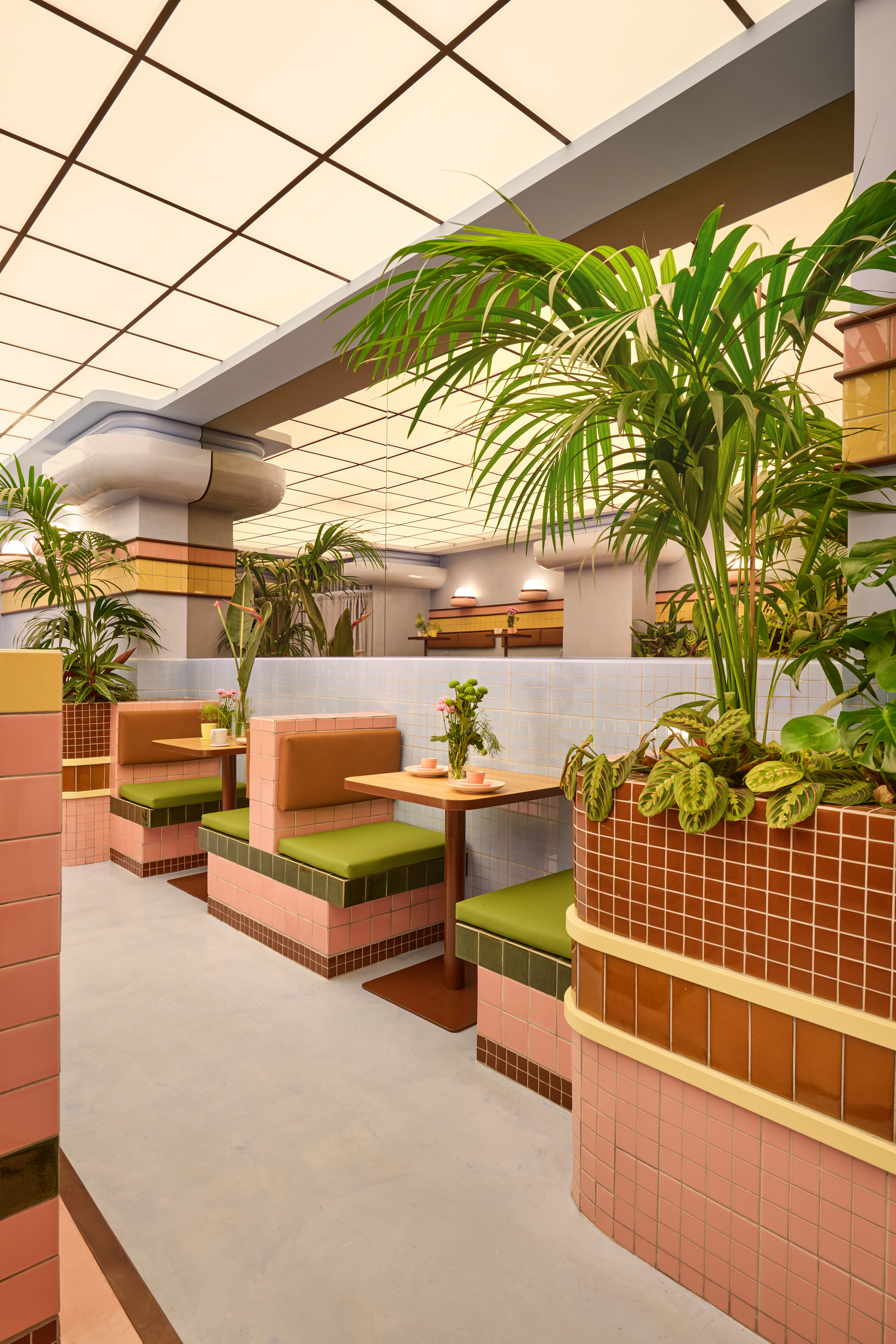 Geometric booths are tiled in ice-cream colour palette of brown, green and pale pink