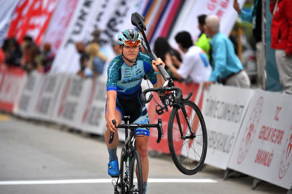 KEMER TURKEY APRIL 14 Arrival Kent Ross of United States and Team Wildlife Generation Pro Cycling carries the bike of Noah Granigan of United States after the crash during the 56th Presidential Cycling Tour Of Turkey 2021 Stage 4 a 1844km stage from Alanya to Kemer TUR2021 tourofturkeyTUR on April 14 2021 in Kemer Turkey Photo by Stuart FranklinGetty Images