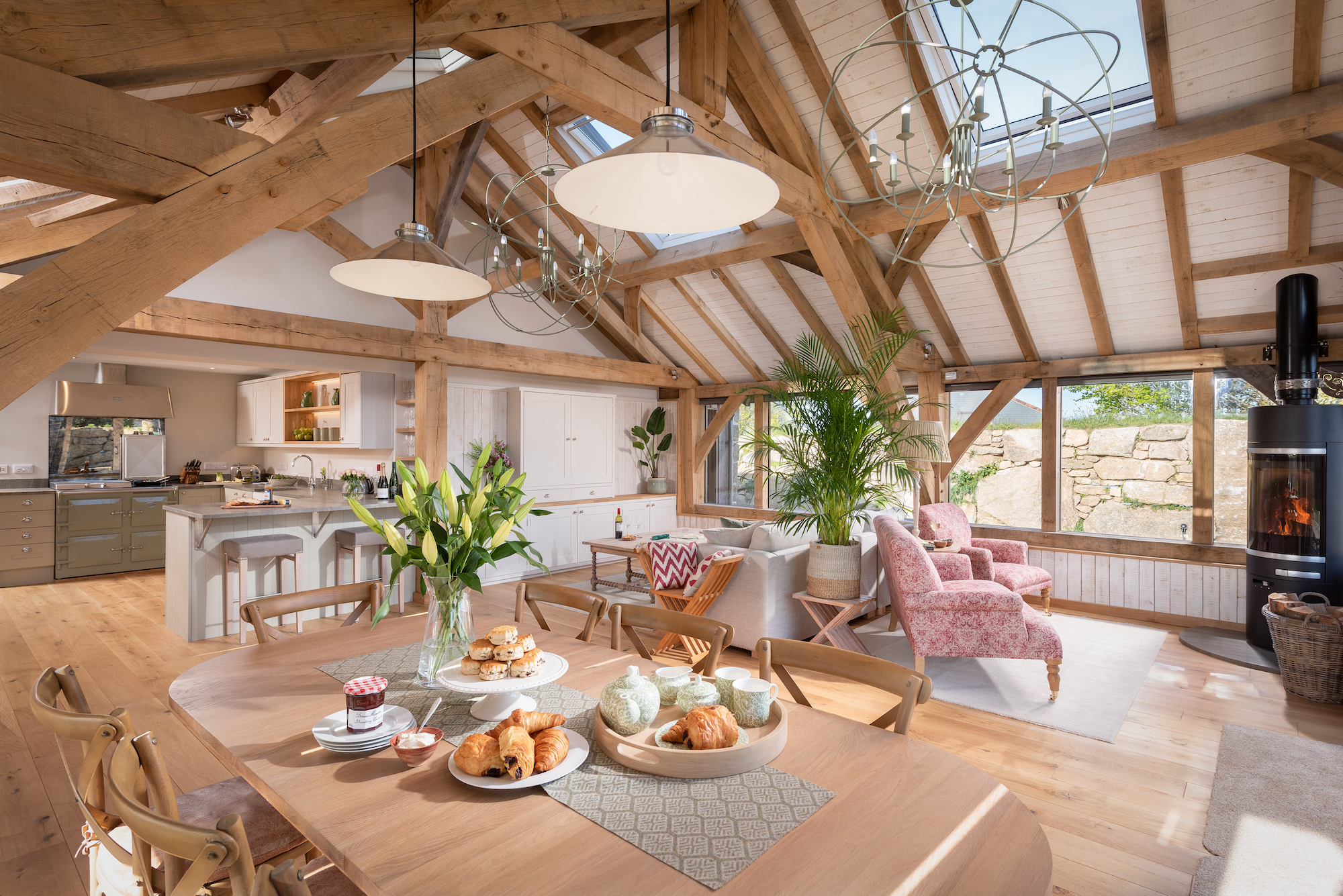 open plan oak frame kitchen living and dining area with vaulted ceiling
