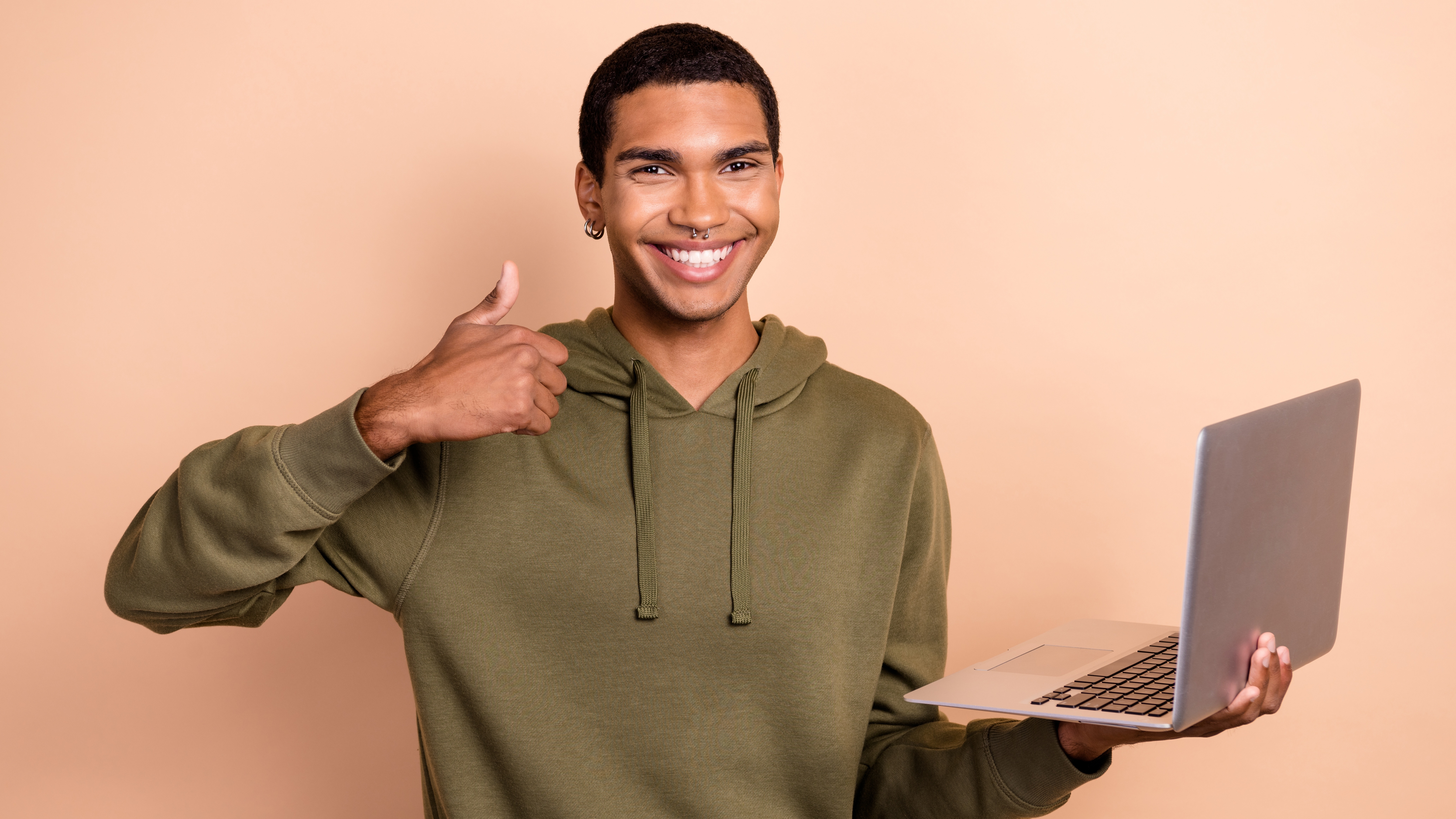 Happy man using a MacBook Air and giving a thumbs up
