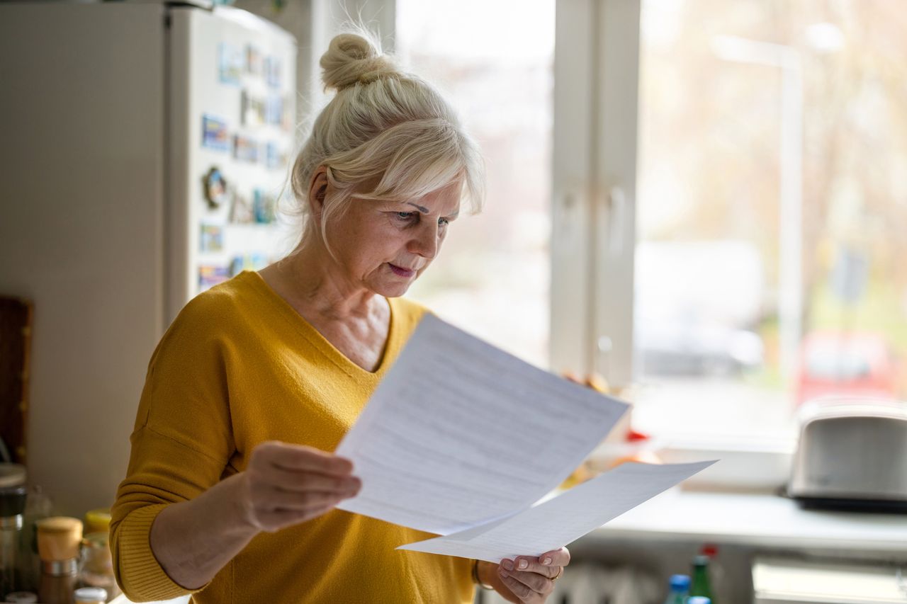 Woman filling out documents, will, financial statements