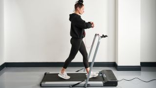 Image shows Sam Hopes, Live Science fitness writer, testing out one of the best walking treadmills: The Bluefin Fitness Task 2.0