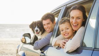family and dog in car