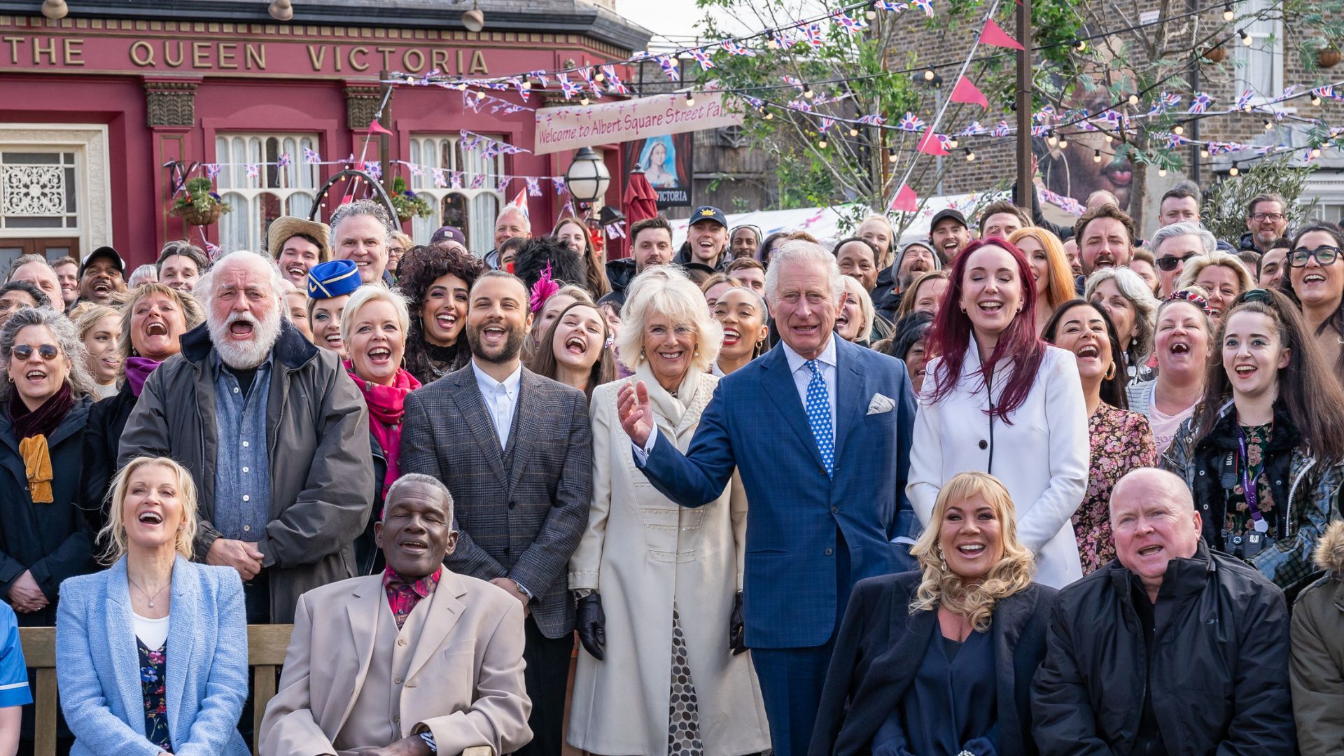 King Charles and Queen Camilla pose for a group photo with members of the cast and crew during a visit to the set of EastEnders at Elstree Studios on March 31, 2022