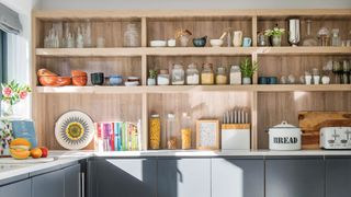 A kitchen with open shelving and storage jars