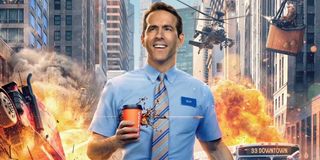 Free Guy Ryan Reynolds walks with a coffee, amidst chaos