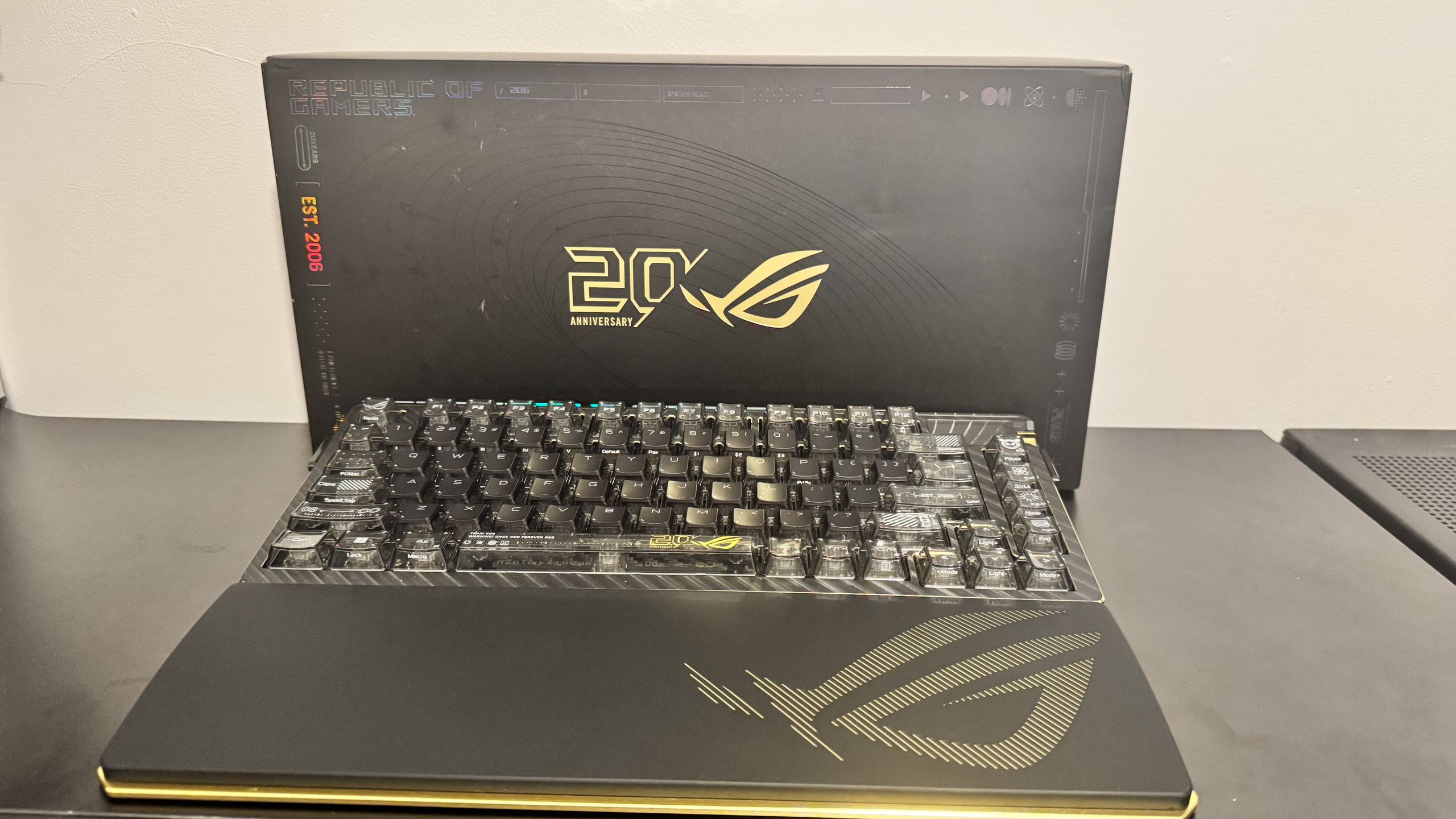 Asus ROG Azoth Extreme Edition 20 on a black table, with a box behind it