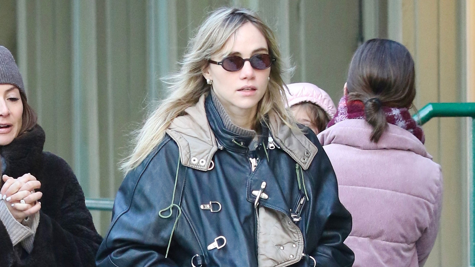Suki Waterhouse wears a bomber jacket, jeans, and Nike sneakers