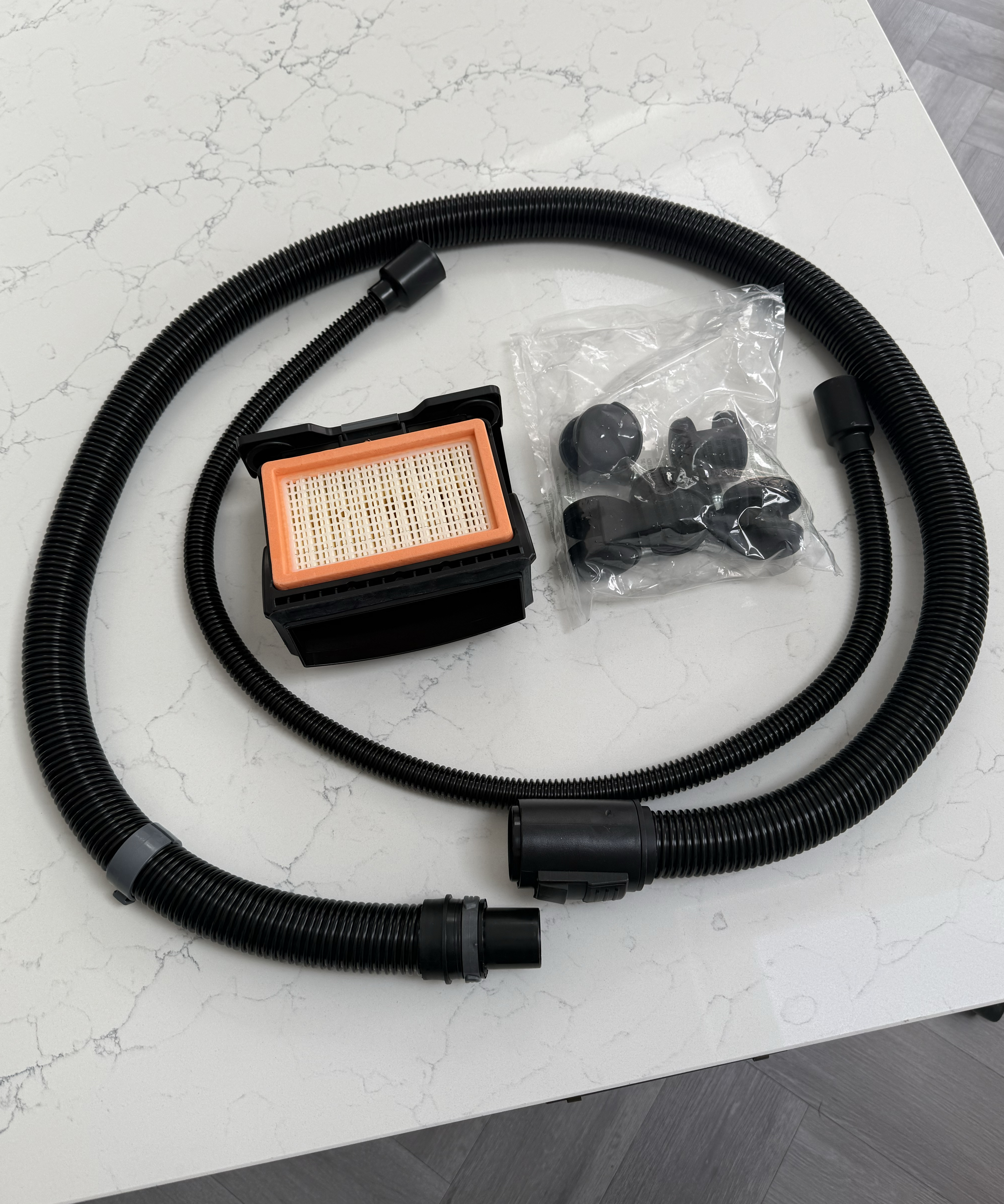 K&amp;auml;rcher WD 6 hose, filter and small parts laid out on a kitchen worktop