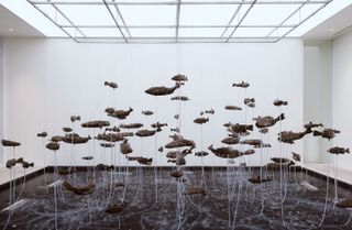 One Hundred Fish Fountain, 2005, by Bruce Nauman, 97 bronze fish of seven different forms, suspended with stainless steel wire from a metal grid