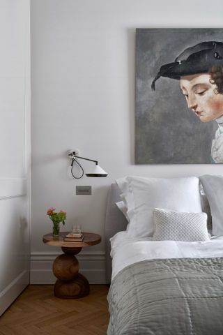 Light grey bedroom with layered bedding