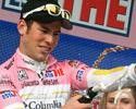 Mark Cavendish uncorks the bubbly to celebrate donning the race leader's maglia rosa.