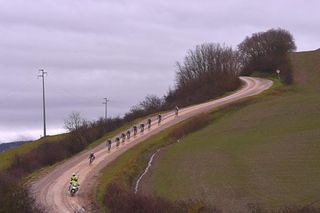 The leaders at Strade Bianche descend a muddy gravel road