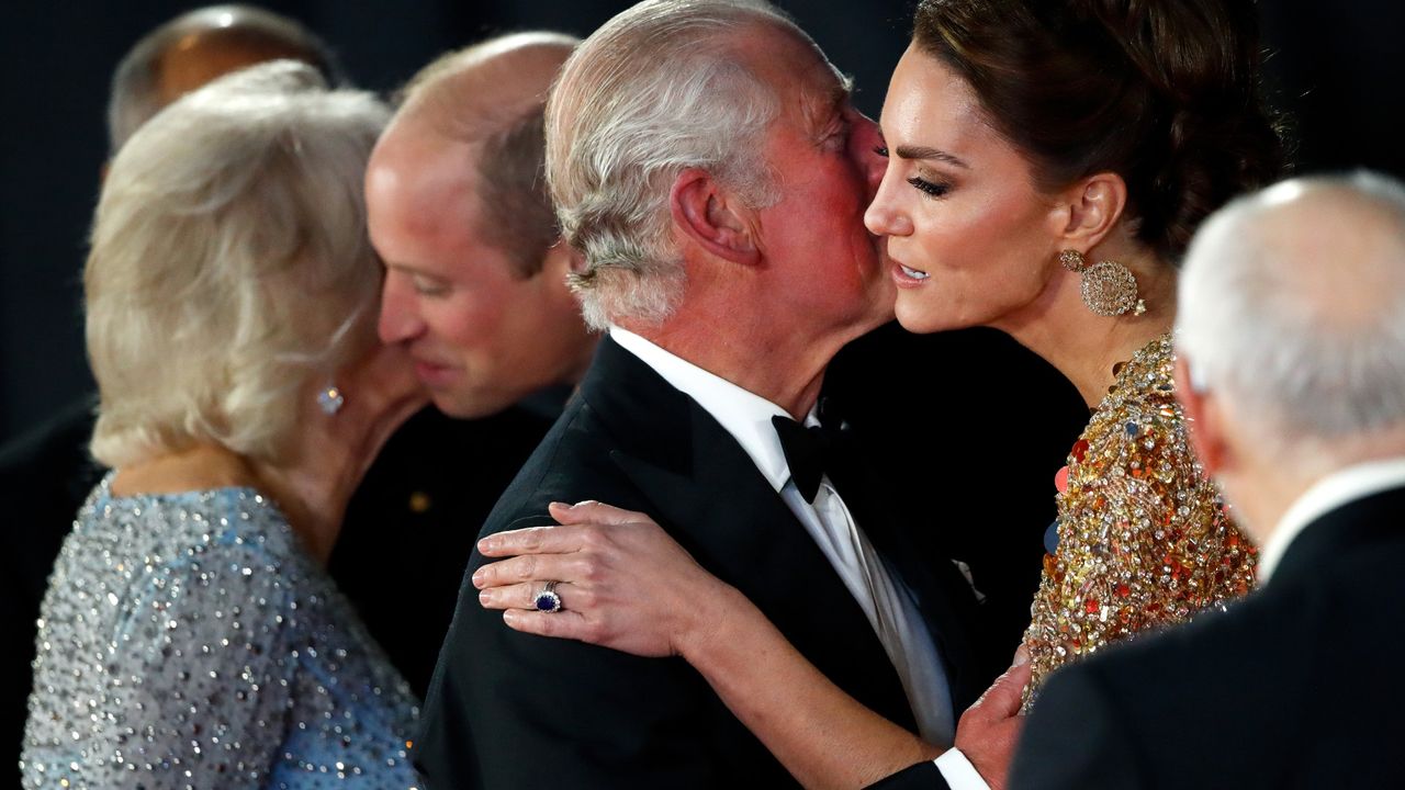 Camilla, Duchess of Cornwall kisses Prince William, Duke of Cambridge and Prince Charles, Prince of Wales kisses Catherine, Duchess of Cambridge as they arrive to attend the &quot;No Time To Die&quot; World Premiere at the Royal Albert Hall on September 28, 2021 in London, England.