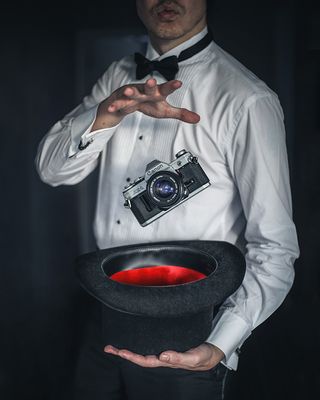 A magician making a Canon AE-1 camera "float", via the magic of levitation photography!