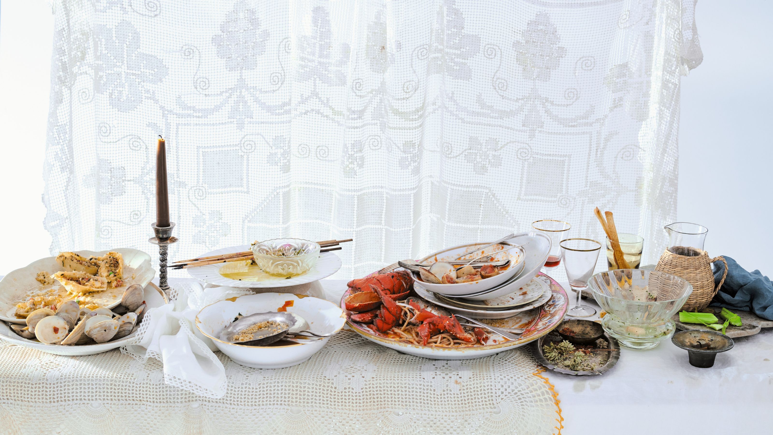 table full of dirty dishes with food on