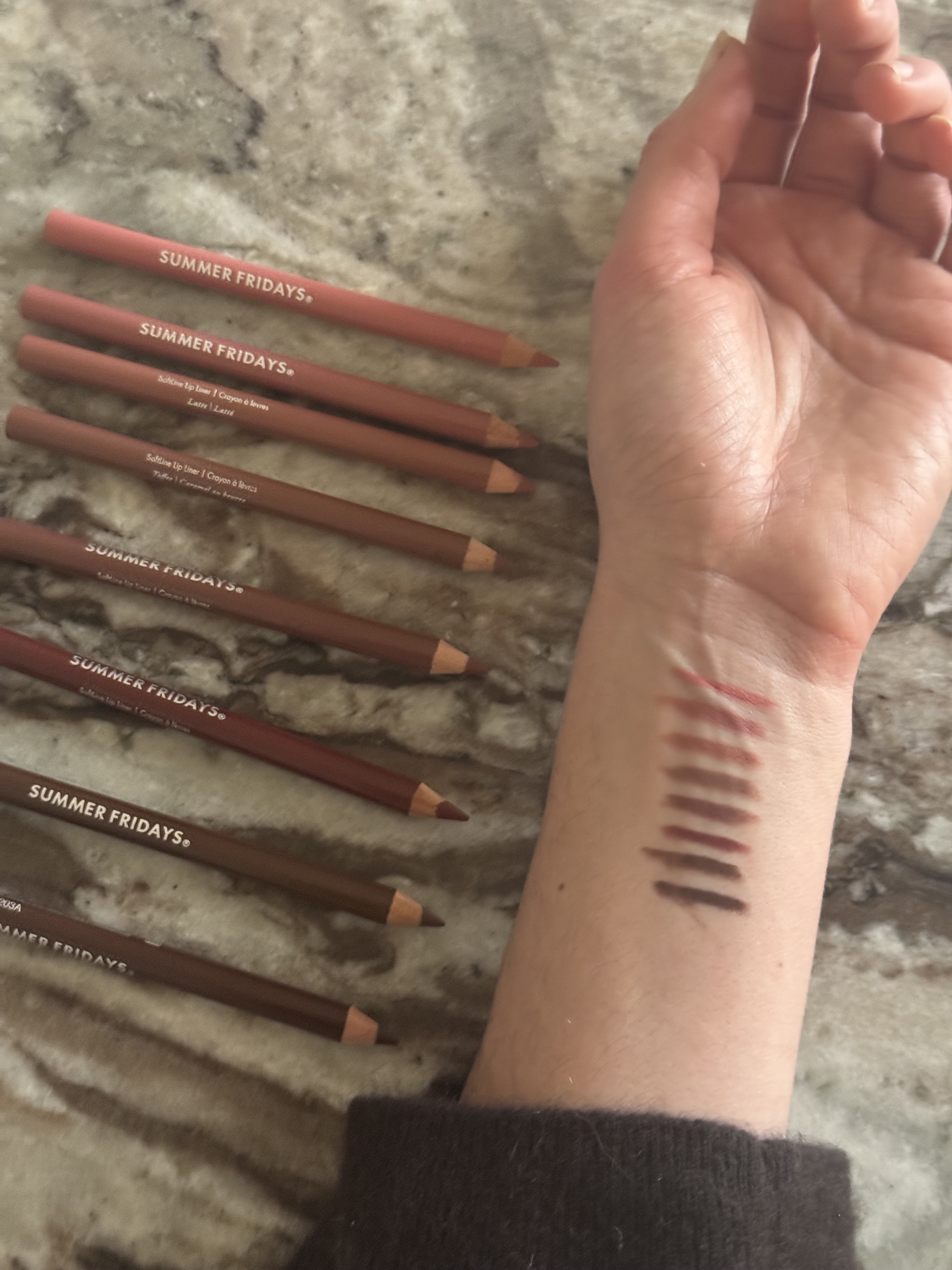 Swatches of the Summer Fridays Softline Lip Pencils on an arm