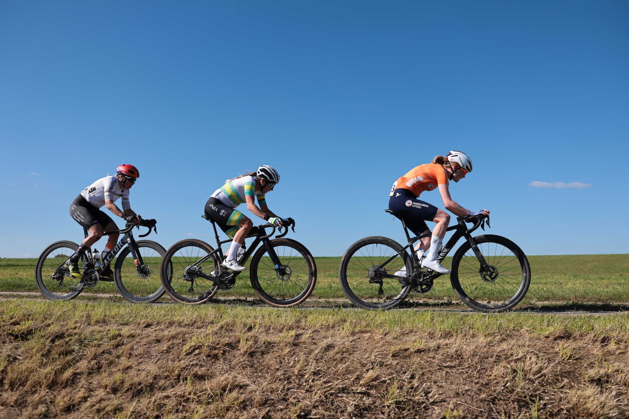 Nicole Frain (Australia) in 2024 at the UCI Gravel World Championships sitting between Puck Pieterse (Netherlands) and Romy Kasper (Germany)