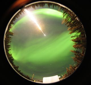 A fisheye photo taken by an automated camera near the entrance gate at the Poker Flat Research Range in Fairbanks, Ala., as a suborbital rocket launches into the northern lights on a science mission on Feb. 18, 2012.