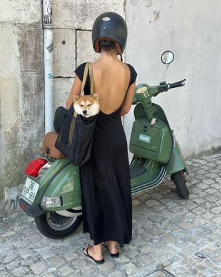 Woman in black dress with low back.