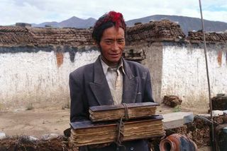 Amchi Tala, a Tibetan doctor, holds precious medical books in a remote region of Western Tibet. The items include the Gyu Shi (Four Tantras), the fundamental Tibetan medical classic written in the 12th century, and a manuscript on compounding medicines,
