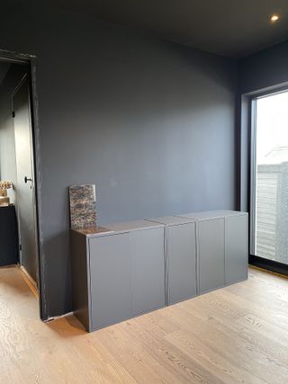 A dark painted IKEA Eket cabinet before renovation