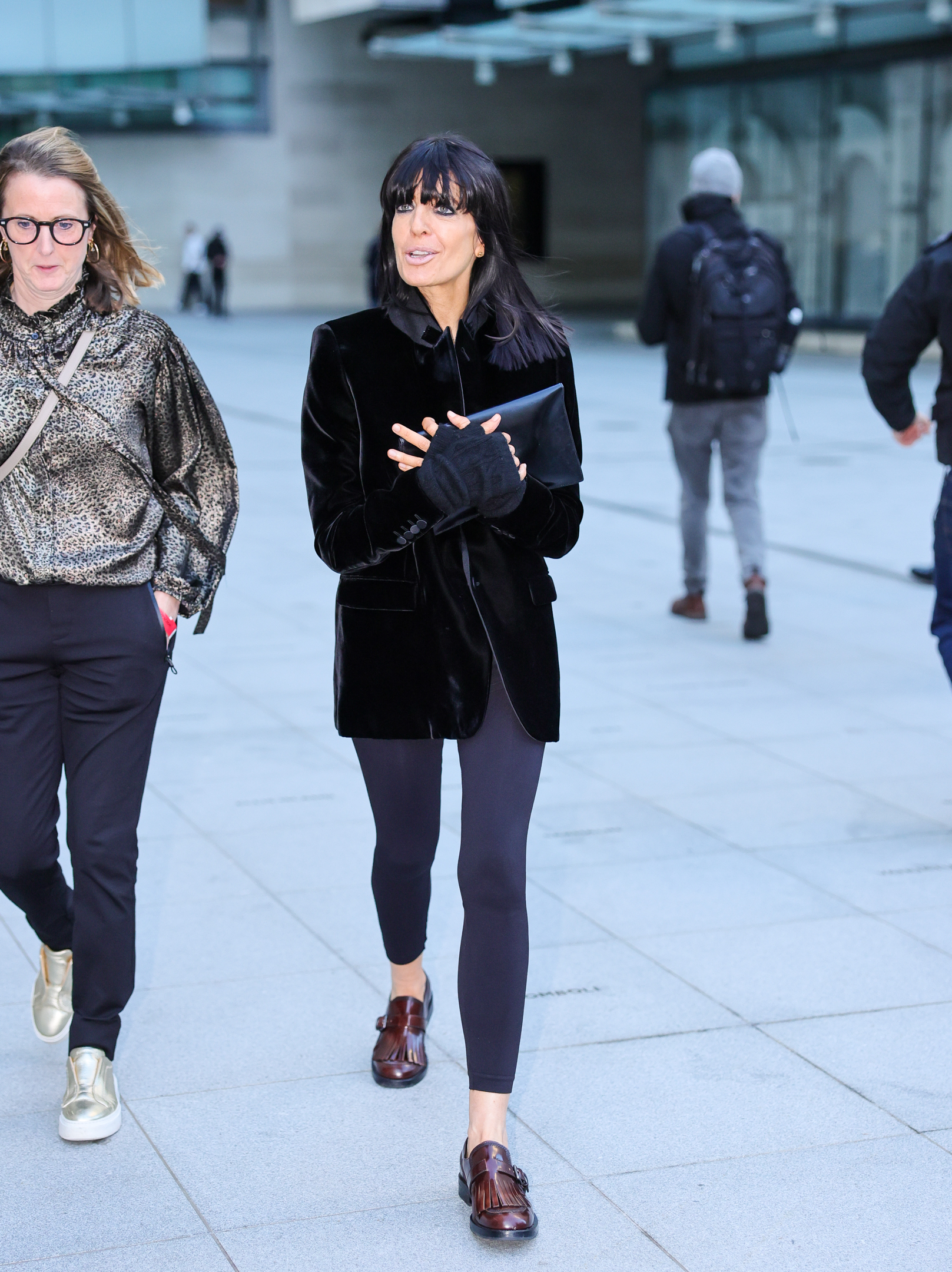 Claudia Winkleman steps out in London wearing dark grey leggings with dark brown fringed monk shoes and a velvet jacket.