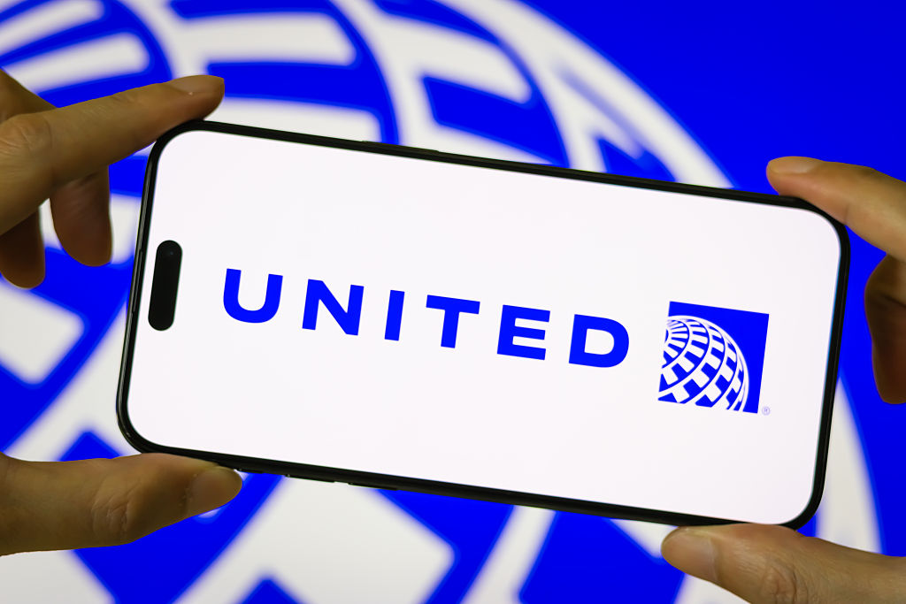 United Airlines Holdings logo displayed on a smartphone screen in front of a blurred brand background.